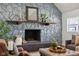 Living room with a stone fireplace, vaulted ceiling, and hardwood floors at 4844 N 700 W, McCordsville, IN 46055