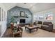 Bright open living room featuring a stone fireplace, hardwood floors, and neutral furniture at 4844 N 700 W, McCordsville, IN 46055