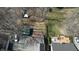 This aerial view of the backyard shows two decks, a privacy fence, mature trees, and an outbuilding at 5014 Melbourne Rd, Indianapolis, IN 46228