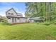 Sprawling backyard with wooden deck, lush lawn, and storage carport at 5014 Melbourne Rd, Indianapolis, IN 46228