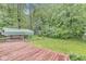 A wooden deck overlooks a huge backyard, offering plenty of privacy at 5014 Melbourne Rd, Indianapolis, IN 46228