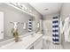 Clean bathroom with tub and shower combination, bright mirror lighting, and elegant decor at 5014 Melbourne Rd, Indianapolis, IN 46228