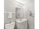 Cozy bathroom featuring a white vanity, large mirror, and a toilet at 5014 Melbourne Rd, Indianapolis, IN 46228