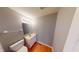 Cozy half bathroom with hardwood floors and neutral wall colors at 5014 Melbourne Rd, Indianapolis, IN 46228