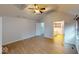 Bright bedroom featuring hardwood floors, ceiling fan, and ensuite bathroom access at 5014 Melbourne Rd, Indianapolis, IN 46228