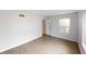 Bright bedroom with neutral walls, wood-look flooring, and a window at 5014 Melbourne Rd, Indianapolis, IN 46228