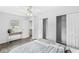 Bright bedroom with a ceiling fan, two closets and light gray wood flooring at 5014 Melbourne Rd, Indianapolis, IN 46228