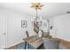 Dining room with wood floors, view to entry way, and modern chandelier at 5014 Melbourne Rd, Indianapolis, IN 46228