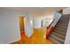 Welcoming entryway with beautiful hardwood floors and staircase leading to the upper level at 5014 Melbourne Rd, Indianapolis, IN 46228