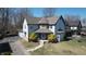 Charming two-story home with stone accents, well-maintained lawn and beautiful front yard landscaping at 5014 Melbourne Rd, Indianapolis, IN 46228
