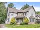 Inviting two story home featuring stone accents, mature landscaping, and ample parking at 5014 Melbourne Rd, Indianapolis, IN 46228