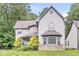 Charming home featuring stone accents, manicured landscaping, and a covered porch at 5014 Melbourne Rd, Indianapolis, IN 46228