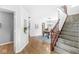 Spacious foyer with hardwood floors, open staircase, and views into the dining room at 5014 Melbourne Rd, Indianapolis, IN 46228