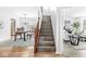 Open foyer with hardwood floors, an open staircase, and views into the dining and living rooms at 5014 Melbourne Rd, Indianapolis, IN 46228