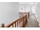 Hallway with hardwood floors, wooden banister and natural light, creating a warm and welcoming atmosphere at 5014 Melbourne Rd, Indianapolis, IN 46228