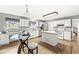 Spacious kitchen with white cabinetry, an island, stainless steel appliances, and a glass top table with chairs at 5014 Melbourne Rd, Indianapolis, IN 46228