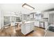 Bright kitchen featuring an island, stainless steel appliances, hardwood floors, and adjacent dining area at 5014 Melbourne Rd, Indianapolis, IN 46228