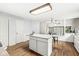 Eat-in kitchen features white cabinets and a view to small table with view to outside at 5014 Melbourne Rd, Indianapolis, IN 46228