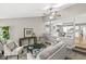 Inviting living room with neutral colors, open to kitchen and dining room creating an open feel at 5014 Melbourne Rd, Indianapolis, IN 46228
