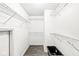 This walk-in closet has adjustable metal shelving and wood-look floors at 5014 Melbourne Rd, Indianapolis, IN 46228