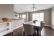 Dining area featuring stylish table with seating and kitchen in background at 505 W Hunters Dr # D, Carmel, IN 46032