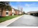 Attractive exterior view showing the building facade, landscaped grounds, and covered parking at 505 W Hunters Dr # D, Carmel, IN 46032