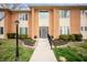 Inviting brick exterior featuring a well-lit walkway leading to the front door at 505 W Hunters Dr # D, Carmel, IN 46032