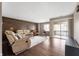 Spacious living room with a decorative wood wall and access to a balcony at 505 W Hunters Dr # D, Carmel, IN 46032