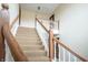 Carpeted staircase with wooden banister and white spindles at 505 W Hunters Dr # D, Carmel, IN 46032