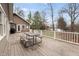 Large wooden deck featuring a picnic table, with a view of trees and a glimpse of the lake beyond at , Columbus, IN 47201