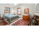 Bright bedroom with a ceiling fan, a colorful area rug, and plentiful natural light from multiple windows at , Columbus, IN 47201