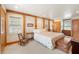 A cozy bedroom featuring exposed wood beams, neutral carpet, and plenty of natural light at , Columbus, IN 47201