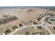 Sprawling aerial view of a neighborhood bordering farmland, showcasing spacious lots and community layout at 5189 Abbeygate Blvd, Bargersville, IN 46106
