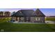 Charming single-story home featuring a brick facade, well-manicured lawn, and festive holiday decorations at 5189 Abbeygate Blvd, Bargersville, IN 46106