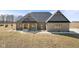 Charming brick home featuring a welcoming porch with timber supports and a beautifully landscaped yard at 5189 Abbeygate Blvd, Bargersville, IN 46106
