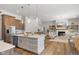Open-concept kitchen with a large island, stainless steel appliances, and seamless flow to the living room at 5189 Abbeygate Blvd, Bargersville, IN 46106