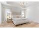 Serene main bedroom featuring a plush bed, tray ceilings, and soft natural light filtering through the windows at 5189 Abbeygate Blvd, Bargersville, IN 46106