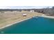 Scenic aerial view of a tranquil pond with a dock, a shelter, and neighboring houses at 5189 Abbeygate Blvd, Bargersville, IN 46106