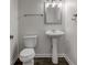 Half bath with wood floors, pedestal sink and commode at 5402 Basin Park Dr, Indianapolis, IN 46239