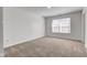 Sunlit bedroom with large window, neutral carpet, and a blank canvas for personalization at 5402 Basin Park Dr, Indianapolis, IN 46239