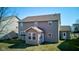 View of the rear of the house featuring a covered porch and an attached sunroom at 5402 Basin Park Dr, Indianapolis, IN 46239
