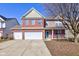 Charming two-story home with a brick facade and a three-car attached garage at 5402 Basin Park Dr, Indianapolis, IN 46239