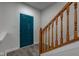 Foyer with teal door, wood staircase, and neutral walls, and hard surface floors at 5402 Basin Park Dr, Indianapolis, IN 46239