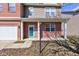 Inviting front porch with brick accents, white columns, and turquoise front door at 5402 Basin Park Dr, Indianapolis, IN 46239