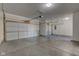This is an oversized three car garage with white doors and concrete floor at 5402 Basin Park Dr, Indianapolis, IN 46239