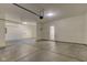 Attached is an empty three car garage with a clean concrete floor at 5402 Basin Park Dr, Indianapolis, IN 46239