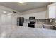 Kitchen features white cabinets, stainless appliances and stylish backsplash at 5402 Basin Park Dr, Indianapolis, IN 46239