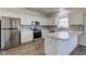 Bright kitchen with white cabinetry, stainless appliances, and wood-look flooring at 5402 Basin Park Dr, Indianapolis, IN 46239