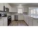 Updated kitchen with white cabinets, stainless appliances, and stylish backsplash at 5402 Basin Park Dr, Indianapolis, IN 46239