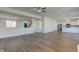 Open-concept living area with stairway and hardwood floors leading to kitchen at 5402 Basin Park Dr, Indianapolis, IN 46239